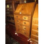 Reproduction mahogany bureau with a fall front above three drawers