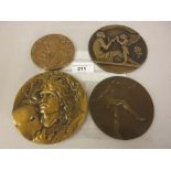 Three large bronze medallions decorated with classical images, together with another bearing a