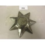 Late 19th / early 20th Century pewter star form badge engraved with a tree within a wreath, No.
