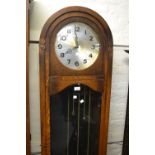 Early to mid 20th Century oak longcase clock, the silvered dial with Arabic numerals, signed