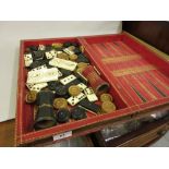 Folding leather covered draughts and backgammon board, quantity of bone and ebony dominoes, a