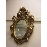 Reproduction Florentine style oval wall mirror with decorative frame and another rectangular antique