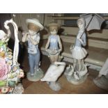 Two Lladro figures, boy and a girl with baskets of flowers, together with a Lladro goose girl figure