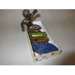 Small lapis lazuli mounted navette shaped trinket box, a small bronze figure of seated putto and a