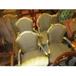 Set of four French style gilt open armchairs with padded backs, overstuffed seats and cabriole front
