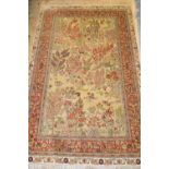 Turkish silk rug decorated with birds in a landscape, approximately 60ins x 36ins Some losses to