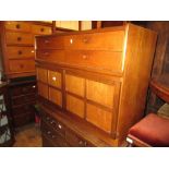 G-plan mid 20th Century teak side board with three drawers above four panelled doors raised on