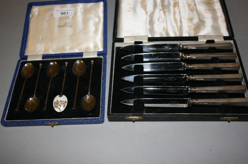 Cased set of six Birmingham silver enamel decorated coffee spoons, together with a cased set of