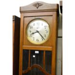 Early to mid 20th Century Continental oak longcase clock, the silvered dial with Arabic numerals and