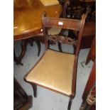 Set of six early 19th Century mahogany sabre leg rail back dining chairs, having carved back rail,