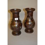 Pair of Japanese brown patinated bronze baluster form vases decorated in relief with birds in