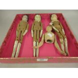 Three various wooden peg dolls, together with a composite half doll
