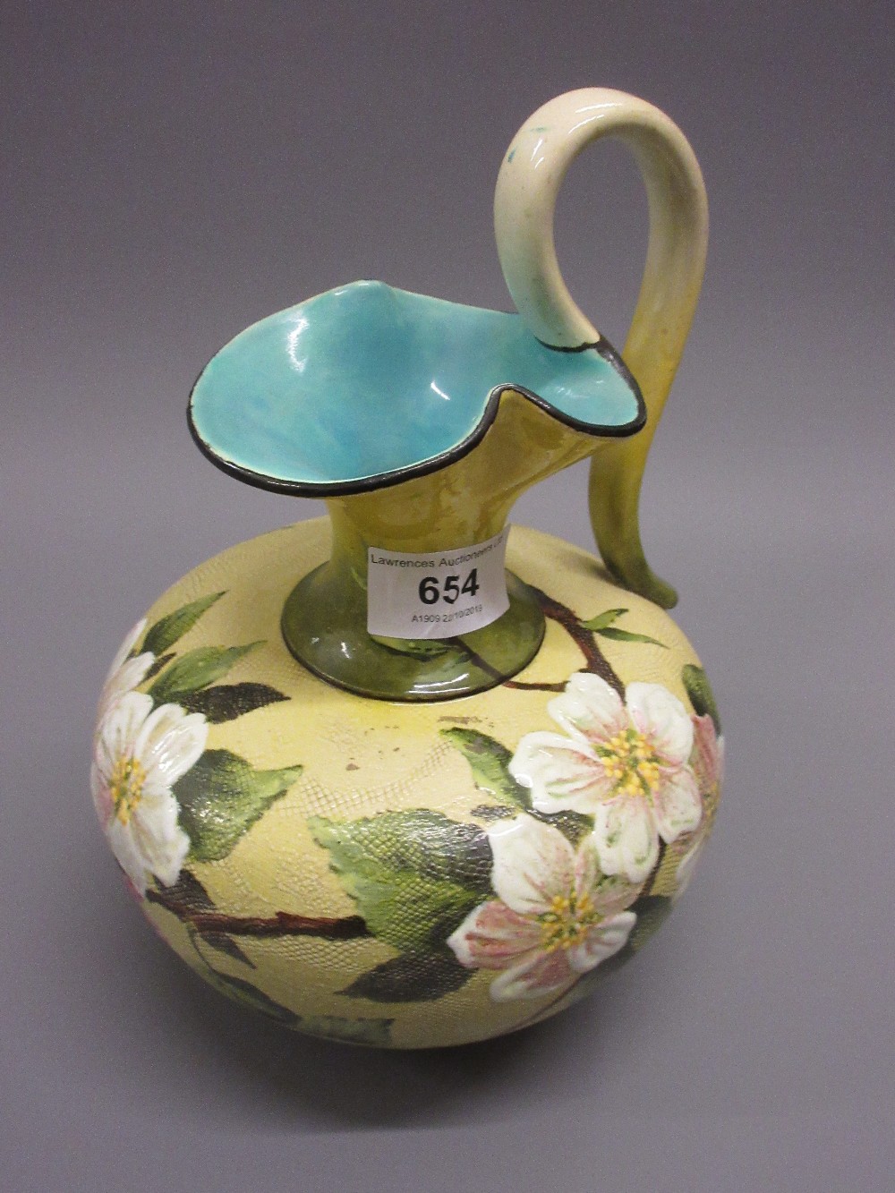 Doulton Slaters Patent jug vase painted with wild flowers and coloured enamels on a yellow mottled