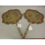 Pair of early 19th Century floral painted on card face screens with turned and gilded handles