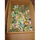 Box containing a collection of various marbles