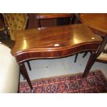19th Century mahogany line inlaid serpentine fronted fold-over card table on turned tapering