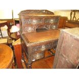 19th Century Continental carved oak writing desk, the superstructure with four drawers and central