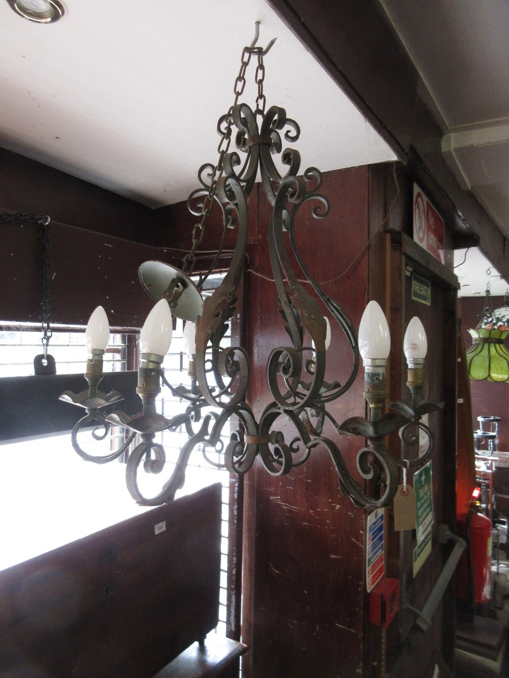 Wrought iron six branch chandelier with verdigris finish on long chain with matching ceiling rose