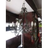 Wrought iron six branch chandelier with verdigris finish on long chain with matching ceiling rose