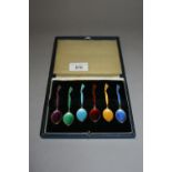 Set of six Birmingham silver gilt and coloured enamel coffee spoons, in fitted box