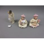 Pair of Continental porcelain nodding head figures together with a Chinese pottery figure of a