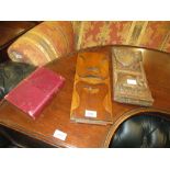 19th Century sliding book rack, a North African carved hardwood book rack and a leather photograph