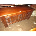 Reproduction oak coffer in 17th Century style with a carved panel front