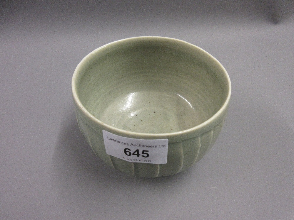 David Leach, a small stoneware bowl with incised decoration in a pale green crackle glaze on a low