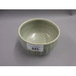 David Leach, a small stoneware bowl with incised decoration in a pale green crackle glaze on a low