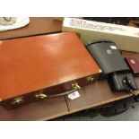 Tan leather briefcase, boxed Ronson razor, pair of modern opera glasses and a pair of binoculars