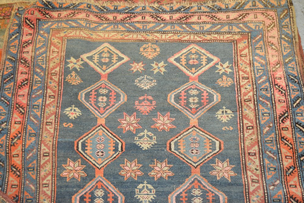 Persian runner of geometric design with multiple borders on blue ground, 120ins x 45ins