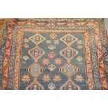 Persian runner of geometric design with multiple borders on blue ground, 120ins x 45ins
