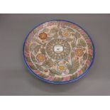 Crown Ducal Charlotte Rhead circular pottery charger with tube lined floral decoration, 12.5ins