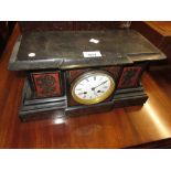 19th Century French black slate and rouge marble mantel clock, the case decorated with figures of