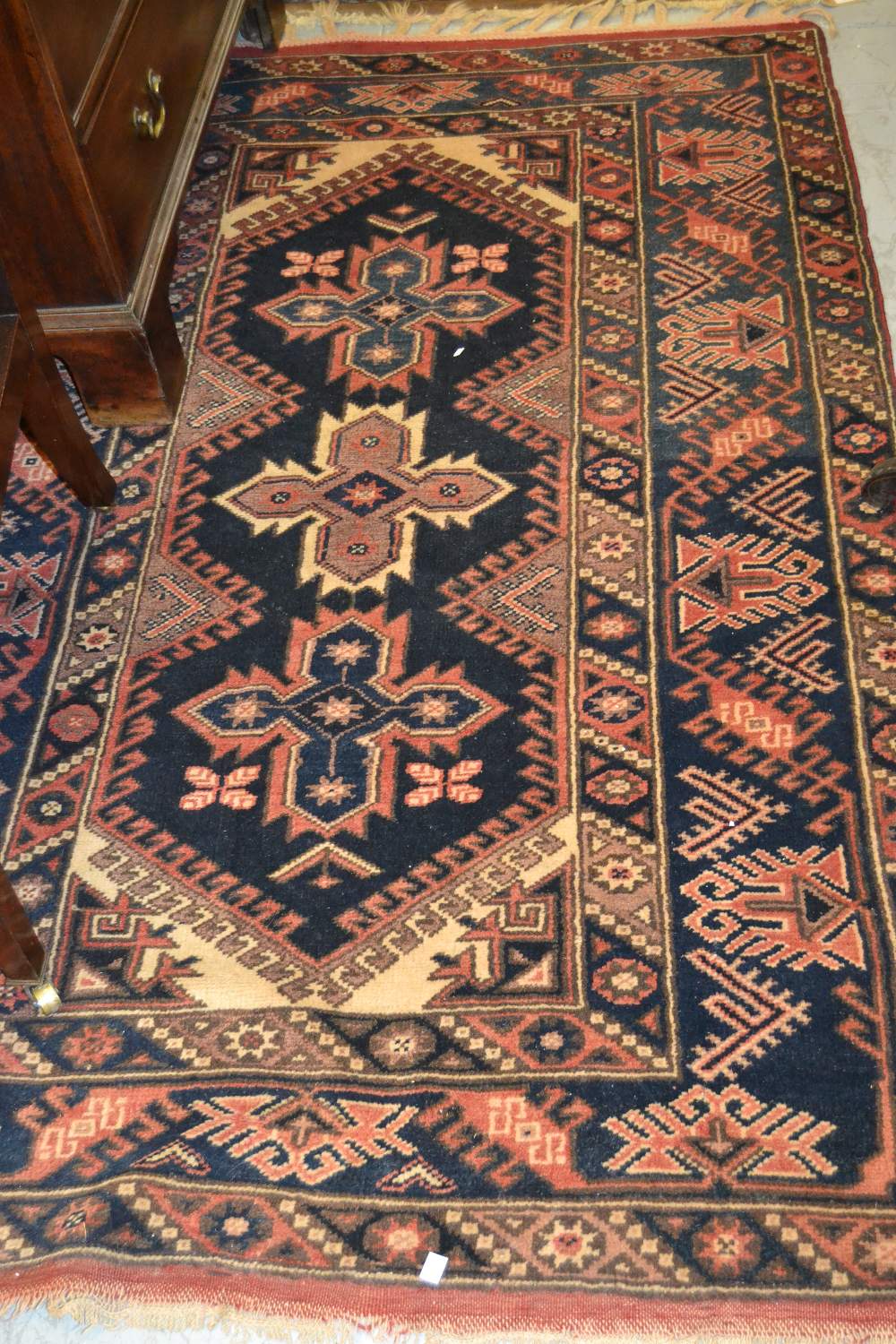 Afghan rug of triple medallion with multiple borders on a blue ground, 72ins x 45ins (at fault),