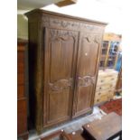18th Century French oak armoire with a moulded cornice above two floral carved and panelled doors