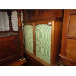19th Century mahogany wall cabinet, the moulded top above two brass grills and pleated doors (at