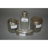 Four various silver mounted glass dressing table bottles