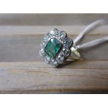 Emerald and diamond dress ring, the central rectangular cushion cut emerald surrounded by ten