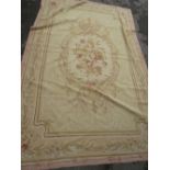 Aubusson needlepoint rug with a central floral medallion on a beige ground with borders, 106ins x