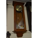 Early 20th Century oak Vienna type two train wall clock, the silvered dial with Arabic numerals