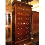 Reproduction mahogany narrow chest with a brushing slide above seven drawers