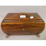 Early 19th Century mahogany boxwood line inlaid sarcophagus shaped tea caddy raised on gilt metal