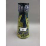 Morris Ware vase decorated with stylised floral designs in shades of blue and mottled green on a