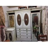 Maple & Co. white painted four door wardrobe having decorative cornice above two central oval cane