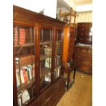 Mahogany bookcase, the moulded cornice above three satinwood crossbanded and astragal glazed