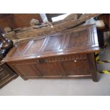 Large antique oak coffer with a four panel hinged top above a three panel star inlaid panel front