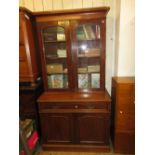 Victorian mahogany bookcase, the moulded cornice above two glazed doors, a long drawer and two panel