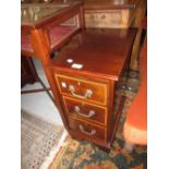 Pair of mahogany crossbanded bedside tables having three drawers with brass swan neck handles, on