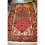 Hamadan rug with a lobed medallion and all-over herati design on a rose ground with ivory corner